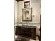 Elegant bathroom with a decorative mirror, vessel sink on a dark wood vanity, and decorative sconces at 7753 E Whisper Rock Trl, Scottsdale, AZ 85266