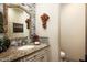 Well-lit bathroom features granite counters, a decorative mirror, and a toilet at 7753 E Whisper Rock Trl, Scottsdale, AZ 85266