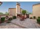 Private courtyard featuring a cozy fireplace, comfortable seating, and elegant desert landscaping at 7753 E Whisper Rock Trl, Scottsdale, AZ 85266