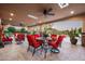Inviting covered patio with comfortable seating, ceiling fan, and views of the professionally landscaped backyard at 7753 E Whisper Rock Trl, Scottsdale, AZ 85266