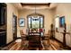 Elegant dining room featuring hardwood floors, stylish lighting, and a window bench seat with neighborhood views at 7753 E Whisper Rock Trl, Scottsdale, AZ 85266