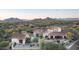 Desert home featuring manicured landscaping, tile roof, outdoor seating area, and mountain views at 7753 E Whisper Rock Trl, Scottsdale, AZ 85266