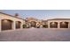 Home with a three-car garage, red tile roof, landscaped front yard, and stone-paved driveway at 7753 E Whisper Rock Trl, Scottsdale, AZ 85266