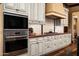 Gourmet kitchen featuring custom cabinetry and high-end stainless steel appliances in an elegant home at 7753 E Whisper Rock Trl, Scottsdale, AZ 85266