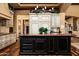 Gourmet kitchen featuring a large island, custom cabinetry, and high-end appliances in an elegant home at 7753 E Whisper Rock Trl, Scottsdale, AZ 85266
