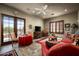 Living room featuring a beamed ceiling, a television, and access to the outdoors through glass doors at 7753 E Whisper Rock Trl, Scottsdale, AZ 85266