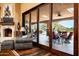 An inviting living room featuring a fireplace, hardwood floors, and a large sliding glass door to the patio at 7753 E Whisper Rock Trl, Scottsdale, AZ 85266