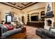Cozy living room featuring a fireplace, comfortable seating, hardwood floors, and custom built-ins at 7753 E Whisper Rock Trl, Scottsdale, AZ 85266