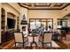 Spacious living room featuring a fireplace, hardwood floors, and access to the outdoor living area at 7753 E Whisper Rock Trl, Scottsdale, AZ 85266