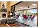 An inviting living room featuring a fireplace, hardwood floors, and a large sliding glass door to the patio at 7753 E Whisper Rock Trl, Scottsdale, AZ 85266
