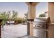 Gourmet outdoor kitchen with high-end Wolf grill, perfect for entertaining and enjoying the serene backyard at 7753 E Whisper Rock Trl, Scottsdale, AZ 85266