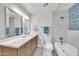 Modern bathroom with double sinks, lots of counter space, modern lighting, and tub/shower combo with new tiling at 8146 N 17Th Dr, Phoenix, AZ 85021