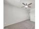 This carpeted bedroom includes a ceiling fan, neutral walls, and is conveniently located next to a door to the bathroom at 8146 N 17Th Dr, Phoenix, AZ 85021