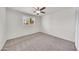 Bright bedroom features a ceiling fan, neutral walls, and a window that provides natural light and scenic outdoor views at 8146 N 17Th Dr, Phoenix, AZ 85021