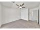 Well-lit bedroom with a ceiling fan, carpeted floor, and a closet located next to an entrance to another room at 8146 N 17Th Dr, Phoenix, AZ 85021