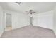 A bright bedroom featuring plush carpet, a ceiling fan, and multiple closets, providing ample storage space at 8146 N 17Th Dr, Phoenix, AZ 85021
