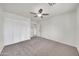 An open bedroom showcasing a ceiling fan, plush carpet, and a double wide closet offering lots of space at 8146 N 17Th Dr, Phoenix, AZ 85021