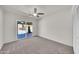 Bright, carpeted bedroom includes a ceiling fan and has a sliding glass door overlooking the backyard and swimming pool at 8146 N 17Th Dr, Phoenix, AZ 85021