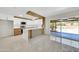 Modern kitchen open to the living space with white cabinets, stainless steel appliances, and a view of the pool at 8146 N 17Th Dr, Phoenix, AZ 85021