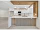 Modern kitchen with white cabinets, stainless steel appliances, and a stylish waterfall countertop at 8146 N 17Th Dr, Phoenix, AZ 85021