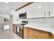 Close-up view of a modern kitchen featuring stainless steel appliances and white subway tile backsplash at 8146 N 17Th Dr, Phoenix, AZ 85021