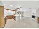Bright and airy living space with tile flooring connecting the kitchen to a cozy fireplace at 8146 N 17Th Dr, Phoenix, AZ 85021