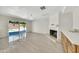 Spacious living area with tile flooring, fireplace, and sliding glass doors leading to the pool at 8146 N 17Th Dr, Phoenix, AZ 85021