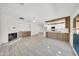 Bright living room featuring tile floors, a fireplace, and an open layout into the kitchen at 8146 N 17Th Dr, Phoenix, AZ 85021