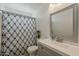 Cozy bathroom with a shower-tub combo, stylish vanity, and modern fixtures at 8404 W Coronado Rd, Phoenix, AZ 85037