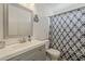 Bathroom with a gray vanity, patterned shower curtain, and modern lighting at 8404 W Coronado Rd, Phoenix, AZ 85037