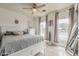 Bright bedroom with a white bed frame, ceiling fan, and natural light at 8404 W Coronado Rd, Phoenix, AZ 85037