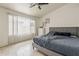 Well-lit bedroom with a comfortable queen-sized bed and tile flooring at 8404 W Coronado Rd, Phoenix, AZ 85037