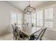 Cozy dining room with stylish light fixture and large windows with plantation shutters at 8404 W Coronado Rd, Phoenix, AZ 85037