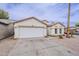 Inviting single story home with a two car garage, desert landscaping and an arched entryway at 8404 W Coronado Rd, Phoenix, AZ 85037
