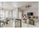 Open-concept kitchen and dining area with stainless steel appliances and a farmhouse sink at 8404 W Coronado Rd, Phoenix, AZ 85037