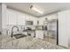 Bright kitchen with stainless steel appliances, granite countertops, and a modern sink faucet at 8404 W Coronado Rd, Phoenix, AZ 85037