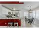 Bright kitchen and dining area with granite countertops, stainless steel appliances, and tile flooring at 8404 W Coronado Rd, Phoenix, AZ 85037