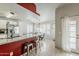 Kitchen with stainless steel appliances, granite countertops and bar seating open to dining area at 8404 W Coronado Rd, Phoenix, AZ 85037