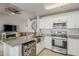 Modern kitchen features stainless steel appliances, granite countertops, and a farmhouse sink at 8404 W Coronado Rd, Phoenix, AZ 85037