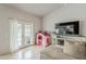 Bright living area with tile flooring, patio access, and entertainment center at 8404 W Coronado Rd, Phoenix, AZ 85037