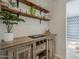Stylish bar area with rustic wood shelves and cabinetry provides an inviting spot for entertaining at 8423 E Heatherbrae Dr, Scottsdale, AZ 85251