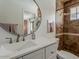 En-suite bathroom featuring a tiled shower, large mirror, and elegant fixtures at 8423 E Heatherbrae Dr, Scottsdale, AZ 85251