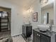 Bathroom with dual vessel sinks, black granite countertops, and stylish fixtures with an open closet at 8423 E Heatherbrae Dr, Scottsdale, AZ 85251
