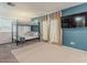Bright bedroom featuring a bunk bed, neutral carpet, and curtains next to a flat screen tv at 8423 E Heatherbrae Dr, Scottsdale, AZ 85251