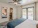 This bedroom features a view of the backyard pool, modern decor, and access to an en-suite bathroom at 8423 E Heatherbrae Dr, Scottsdale, AZ 85251