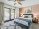 This bedroom features modern decor with a stylish bed, a soft rug, and a door leading to the backyard at 8423 E Heatherbrae Dr, Scottsdale, AZ 85251