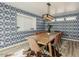 Inviting dining room with stylish wallpaper, a modern light fixture, and seating for eight at 8423 E Heatherbrae Dr, Scottsdale, AZ 85251