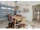 Dining room featuring a large wooden table with stylish seating and a striking decorative wall at 8423 E Heatherbrae Dr, Scottsdale, AZ 85251