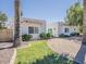 Charming single-story home features lush landscaping, a circular driveway, and a terra cotta roof at 8423 E Heatherbrae Dr, Scottsdale, AZ 85251