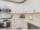 Bright kitchen featuring white cabinets, stainless steel appliances, and subway tile backsplash at 8423 E Heatherbrae Dr, Scottsdale, AZ 85251